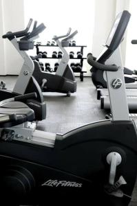 a gym with several cardio machines in a room at Condo/ Depa - Marea Azul - Playa del Carmen in Playa del Carmen