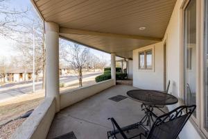 a patio with a table and chairs on a porch at B 32-1 Spacious Villa Close to Pool in Branson