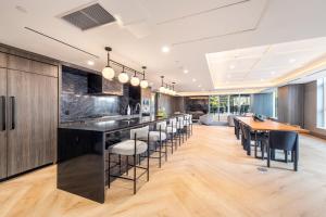 an open kitchen with a bar with stools at Level Downtown - Howe in Vancouver