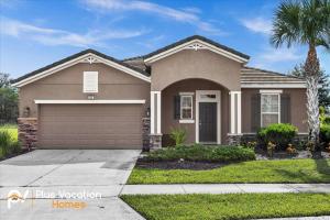 a house with a garage in a residential neighborhood at 4159 -Private Pool&Spa at Resort-slides in Davenport