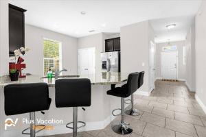a kitchen with black chairs and a counter top at 4159 -Private Pool&Spa at Resort-slides in Davenport