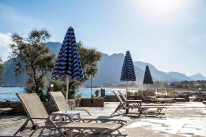 a group of chairs and umbrellas on a beach at Blue Beach Villas Apartments in Stavros