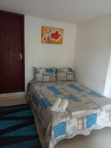 a bedroom with a bed with two slippers on it at GO Hotelaria in Búzios +52 photos