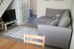 a living room with a couch and a television at Littledown in Bournemouth