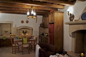 a kitchen and dining room with a table and a kitchen with a fireplace at Eleni's Stately Home, picturesque location, By ThinkVilla in Garazo