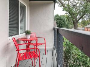 a red table and chairs on a porch at HOLLY FIRST FLOOR 2 King Beds in Kansas City