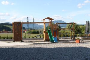 a playground with a slide and a swing at Liptovsky Zrub in Gôtovany +18 photos