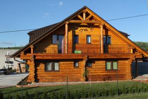 a log cabin with a balcony on top of it at Liptovsky Zrub in Gôtovany