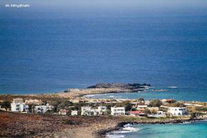 a group of houses on a hill near the ocean at Blue Beach Villas Apartments in Stavros