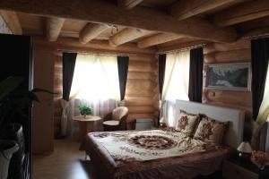 a bedroom with a bed in a room with wooden walls at Liptovsky Zrub in Gôtovany