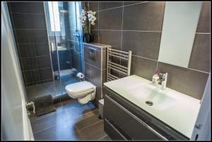 a bathroom with a sink and a toilet and a shower at Superbe 120m2 au Suquet - Property With Style in Cannes
