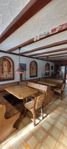 a dining room with a wooden table and chairs at Black Bear Bikers Pub-Hotel in Kempfeld