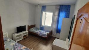 a small room with a bed and a window at ARBI GUEST House in Kukës