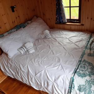 a large white bed in a room with a window at Eco Accommodation Cornflower in Craven Arms