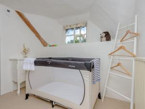 una habitación con una máquina de coser y un estante en Eton Cottage, en Farnham