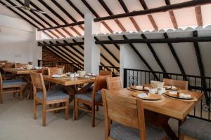 a dining room with wooden tables and chairs at Terra Inn Hotel Boutique in Guaduas