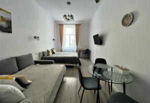 a living room with a couch and a table at Iris apartment on Popovich in Lviv