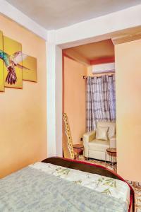 a hotel room with a bed and a chair at Beautiful- 1 Bedroom Apartment - Parking on site in Douala