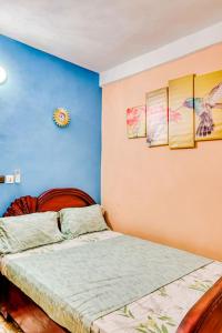 a bedroom with a bed and a blue wall at Beautiful- 1 Bedroom Apartment - Parking on site in Douala