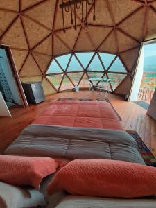 a large room with a large bed in a tent at El Rodeo Glamping in Toca