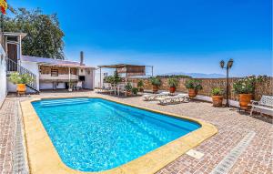 a swimming pool in the backyard of a house at Stunning Home In Cuevas Del Campo With House A Mountain View in Cuevas del Campo