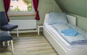 a small room with a bed and a window at Amazing Home In Neubrandenburg With Wifi And 3 Bedrooms in Neubrandenburg