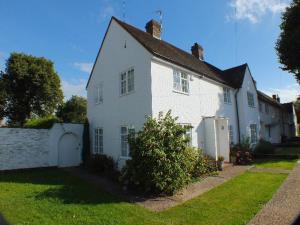 ウィンチェルシーにあるWinchelsea Cottageの芝生の庭のある大きな白い家