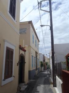 an alley with buildings and a pole on a street at Archontiko Pataka in Rhodes Town