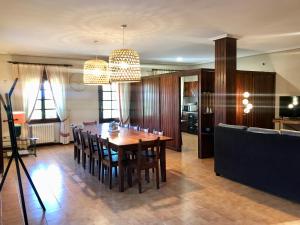 a dining room with a wooden table and chairs at Casa en Cambeo in Ourense