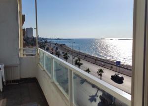 a view of the ocean from the balcony of a building at Big Seafront Apartment in Saida Lebanon in Saïda