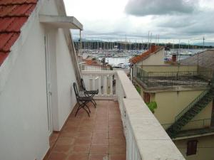 a balcony with a chair and a view of a harbor at House Vodice in Vodice