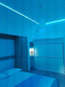 a room with a bed with blue lights on it at Nuida Casa Vacanze in Capri