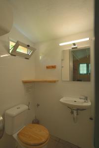 a bathroom with a toilet and a sink and a mirror at Slow Life Camping Venta del Moro in Venta del Moro