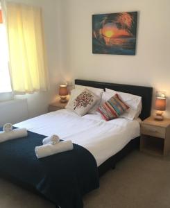 a bedroom with a bed with two towels on it at Simla Bungalow, Tetney in Tetney