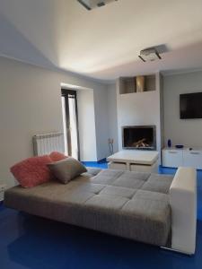 a bedroom with a large bed and a fireplace at Casa Vacanza "Marinella" in Sulmona