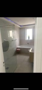 a bathroom with a shower and a bath tub at Perfect 4 bedroom 2 bathroom Home in Edinburgh
