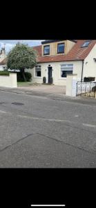 an empty street in front of a house at Perfect 4 bedroom 2 bathroom Home in Edinburgh