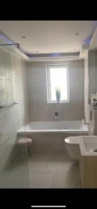 a bathroom with a bath tub and a window at Perfect 4 bedroom 2 bathroom Home in Edinburgh