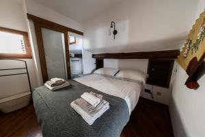 a bedroom with a bed with towels on it at TINA’S APARTMENT in Florence
