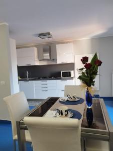 a kitchen with a table with a vase of flowers on it at Casa Vacanza "Marinella" in Sulmona