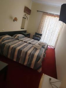 a bedroom with a bed and a window at Ermionida in Kranidi