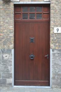 a wooden garage door with a wrought iron at The Carmelite in Ieper