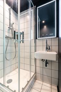 a bathroom with a shower and a sink at Graphik Montparnasse in Paris