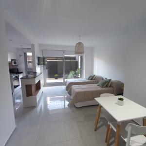 a living room with a couch and a table at PELLERANO APARTMENT in Adrogué