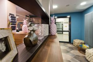 a store with pink vases sitting on a counter at elaya hotel munich city, Trademark Collection by Wyndham in Munich