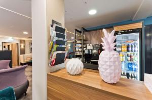 a store with two vases on a counter with a refrigerator at elaya hotel munich city, Trademark Collection by Wyndham in Munich +26 photos
