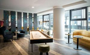 a lobby with a pool table in a room at elaya hotel oberhausen in Oberhausen