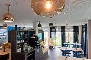 a living room with a table and some chairs at ANA Living Stuttgart by Arthotel ANA in Böblingen