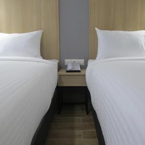 Postel nebo postele na pokoji v ubytování Hotel Citradream Tugu Yogyakarta