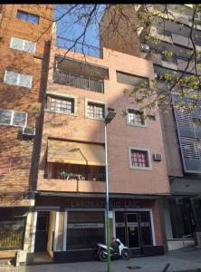 a building with a motorcycle parked in front of it at Tucuman Centro Departamento in San Miguel de Tucumán